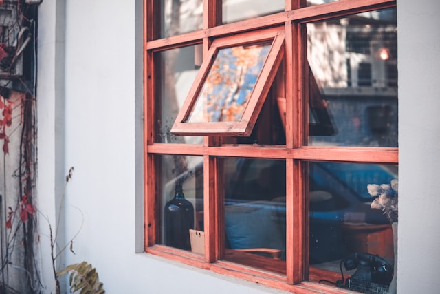Glass window with brown wooden frame.